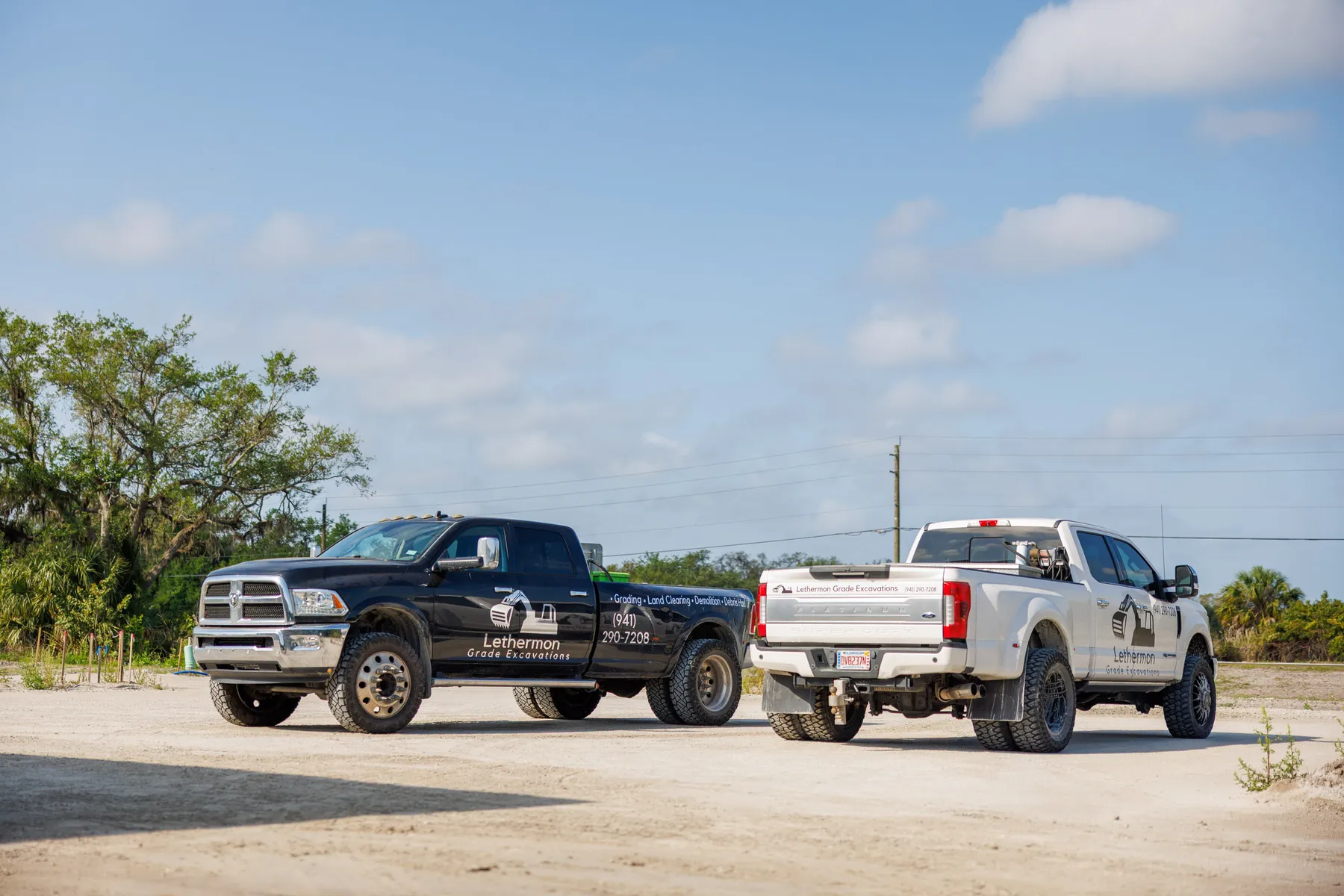 Lethermon Grade Excavations branded truck fleet in Southwest Florida — grading, land clearing, demolition, and debris hauling with phone number (941) 290-7208